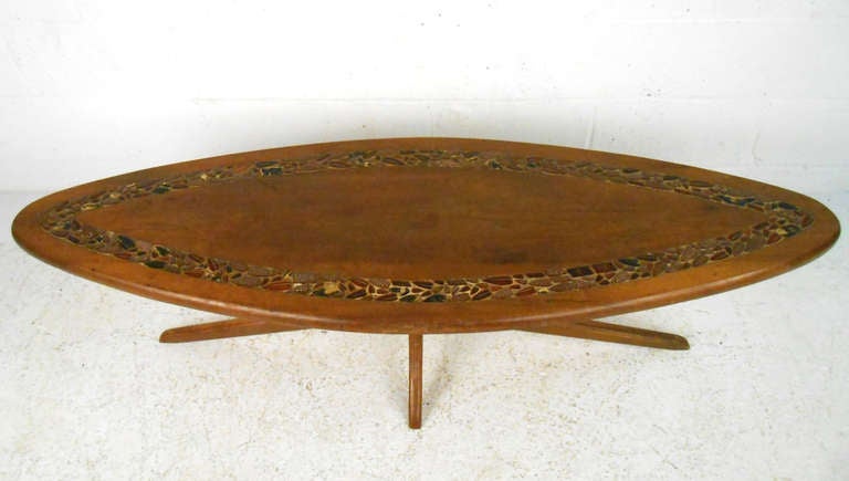 This midcentury coffee table features a Pearsall style base, with a unique decorative inlay top. Refinishing suggested, please confirm item location (NY or NJ).