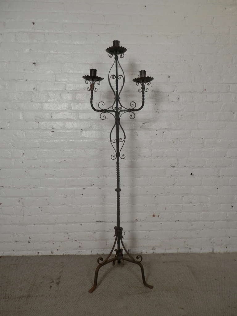 Tall wrought iron torchier with three candle holder and tripod base. Lovely detailed iron work.

(Please confirm item location - NY or NJ - with dealer)