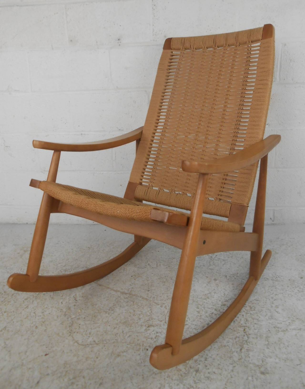 Intricately woven rope cord rocker in the style of Hans Wegner. Stamped 