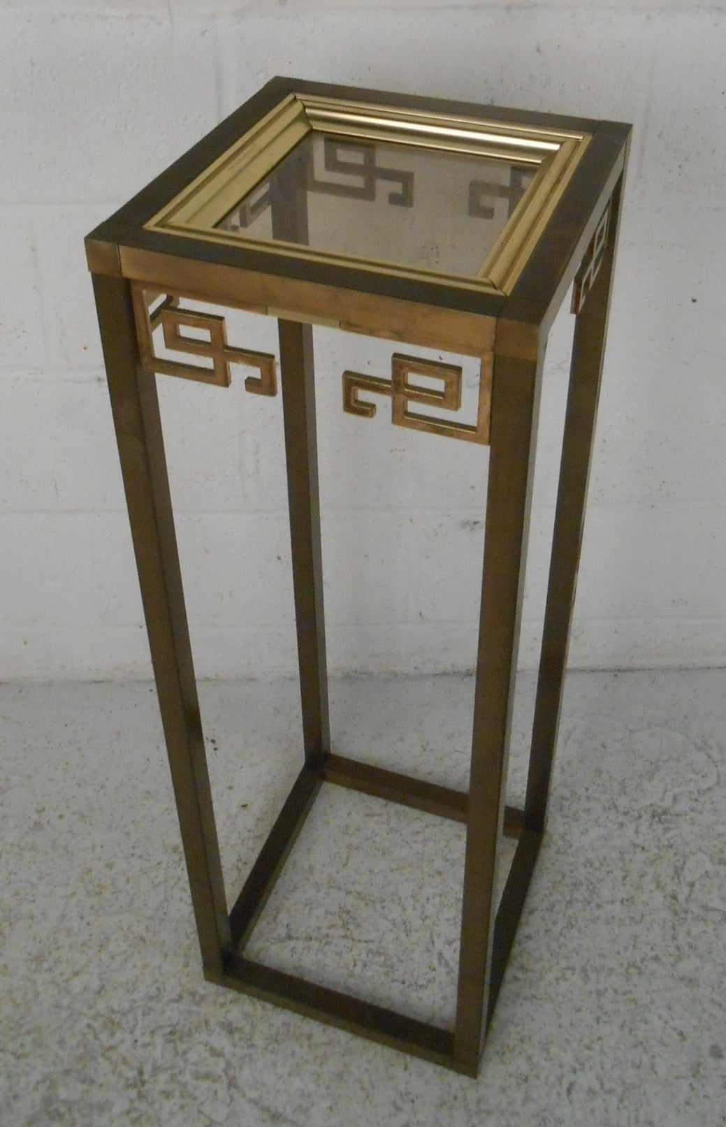 Brass and glass pedestal table by Mastercraft. Excellent pedestal table, perfect for displaying plants or sculpture. Please confirm item location (NY or NJ) with dealer.