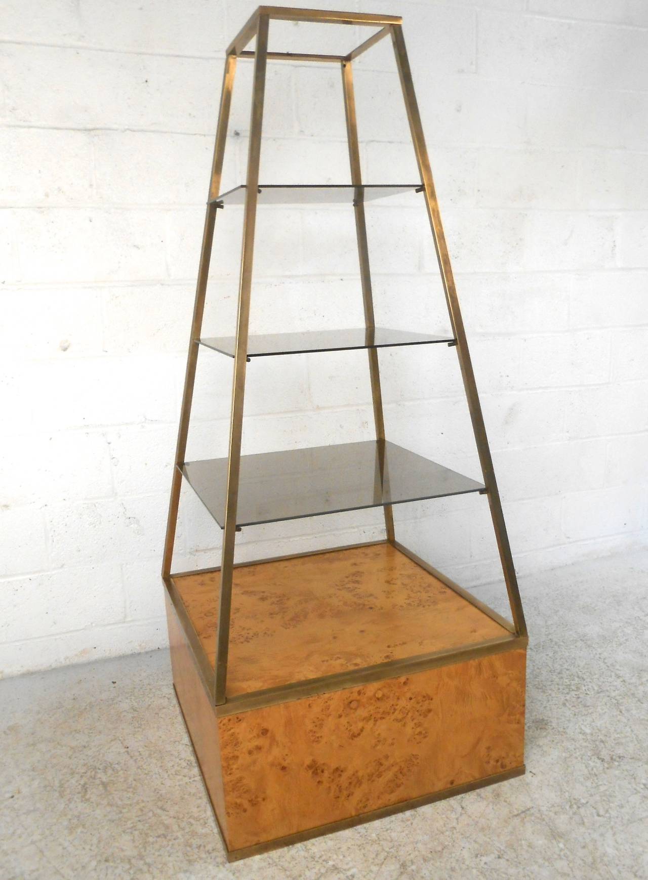 This unique vintage display unit features a wonderful Baughman style burl wood base, with pyramid style fixture housing three smoked glass shelves. Perfect for unique home or shop display. Please confirm item location (NY or NJ).