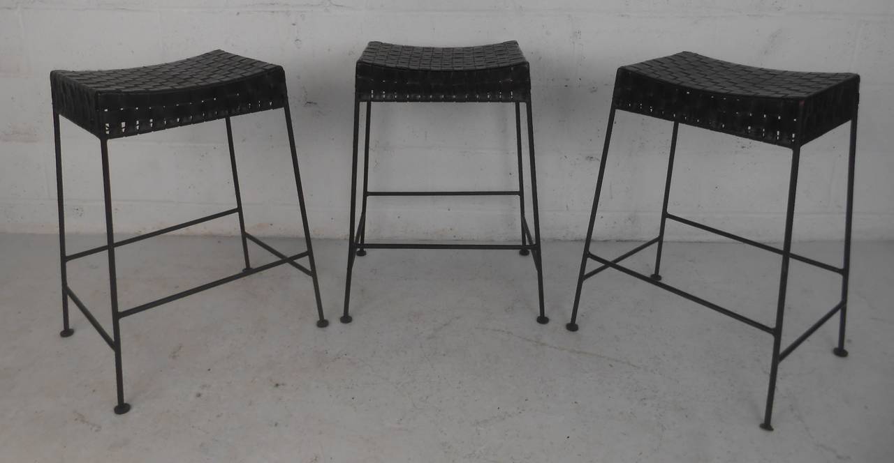 Set of three woven top leather stools with iron bases make a stylish addition to home or business bar.  Please confirm item location (NY or NJ) with dealer.