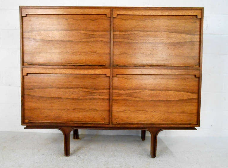 This beautiful design by 1950s Italian designer Gianfranco Frattini is a beautiful piece for home or business. Spacious tambour cabinets provide plenty of storage space, while Frattini's unique Mid-Century design make this a stand out piece. Please