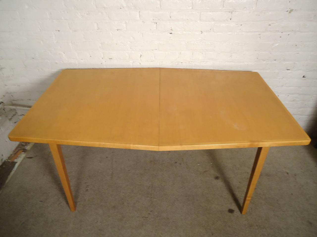 Unusual dining table designed by Jens Risom. Beautiful blonde maple grain, unique hexagon shape. Comes with two leaves to extend to 8 feet long.
Chairs pictured are not part of this listing, but are available for a limited time.

(Please confirm