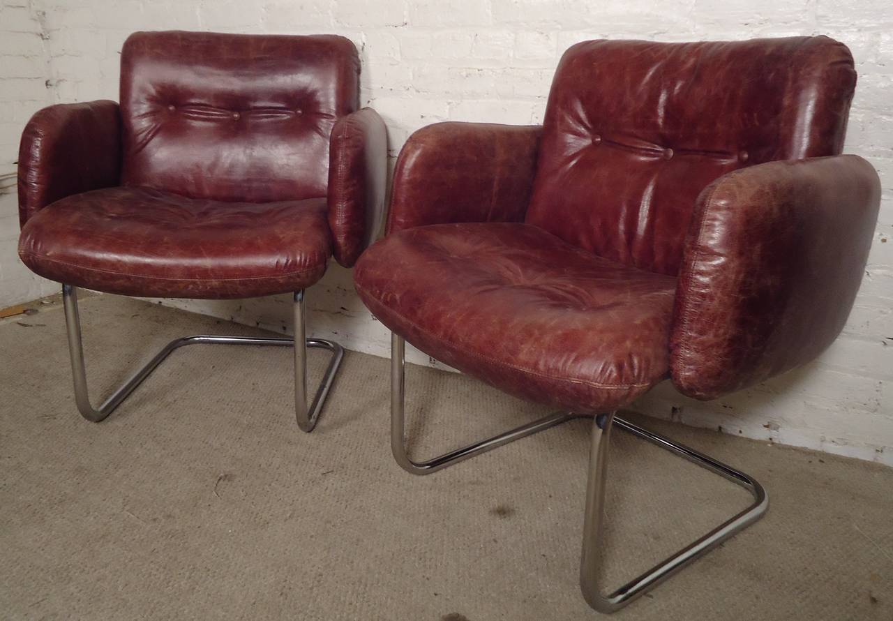 Vintage pair of comfortable armchairs designed by Harvey Probber. Tufted leather cushions and bent tubular chrome legs. Attractive age and patina to leather.

(Please confirm item location - NY or NJ - with dealer).
