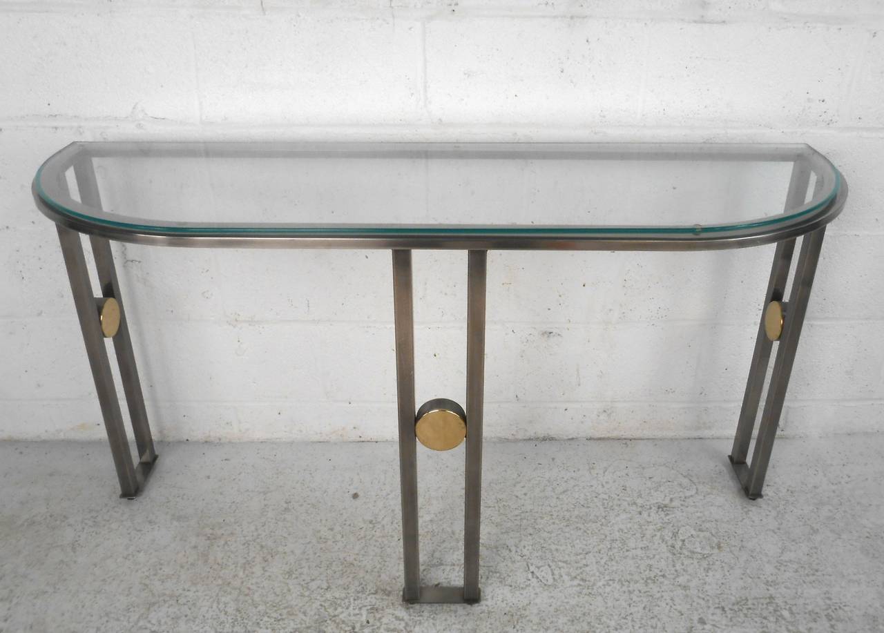 This steel and glass console is perfect for use in any room, providing a stylish and simple side table for display or otherwise. Please confirm item location (NY or NJ).