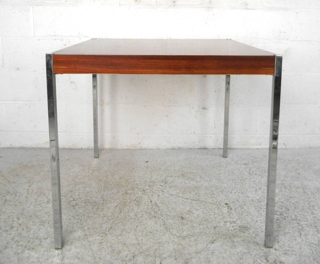 This rosewood top table sits sturdily on chrome legs, and makes a wonderful and versatile table for any setting. Please confirm item location (NY or NJ).