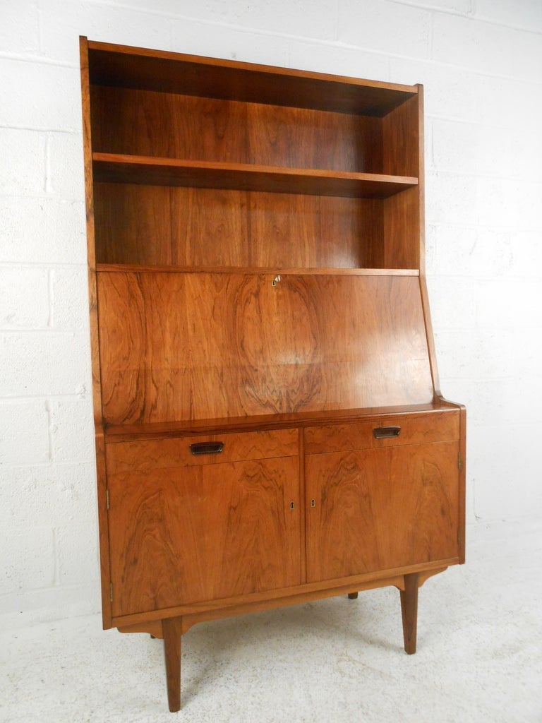 Danish rosewood secretary desk with slant front writing surface and storage cabinet below. Please confirm item location (NY or NJ) with dealer.