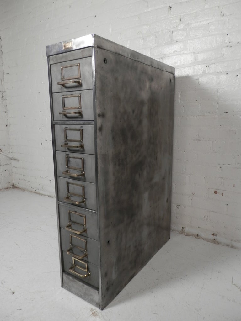 Industrial metal file cabinet with brass hardware. Extremely heavy solid piece of furniture. Stripped to give a handsome machine age look.
Each file measures 7 1/2w 26d 3 1/2h.

(Please confirm item location - NY or NJ - with dealer)