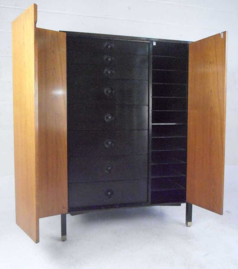 Mahogany chest with two folding doors concealing eight drawers with brass pulls and ten glass shelves. Felt lined top drawer marked with metal tag. Please confirm item location (NY or NJ) with dealer.