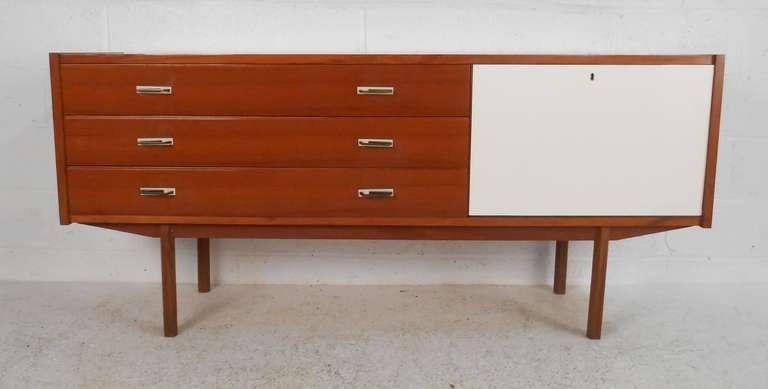 Smaller scale Italian minimalist design credenza with three drawers and drop door concealing pull out shelves. Please confirm item location (NY or NJ) with dealer.