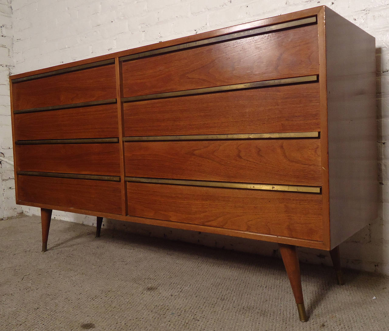 Vintage American made walnut dresser in the style of McCobb.
Eight brass trimmed drawers on beautifully tapered legs. Very elegant and well-built.
Pictures shown are before refinishing.

(Please confirm item location - NY or NJ - with dealer).