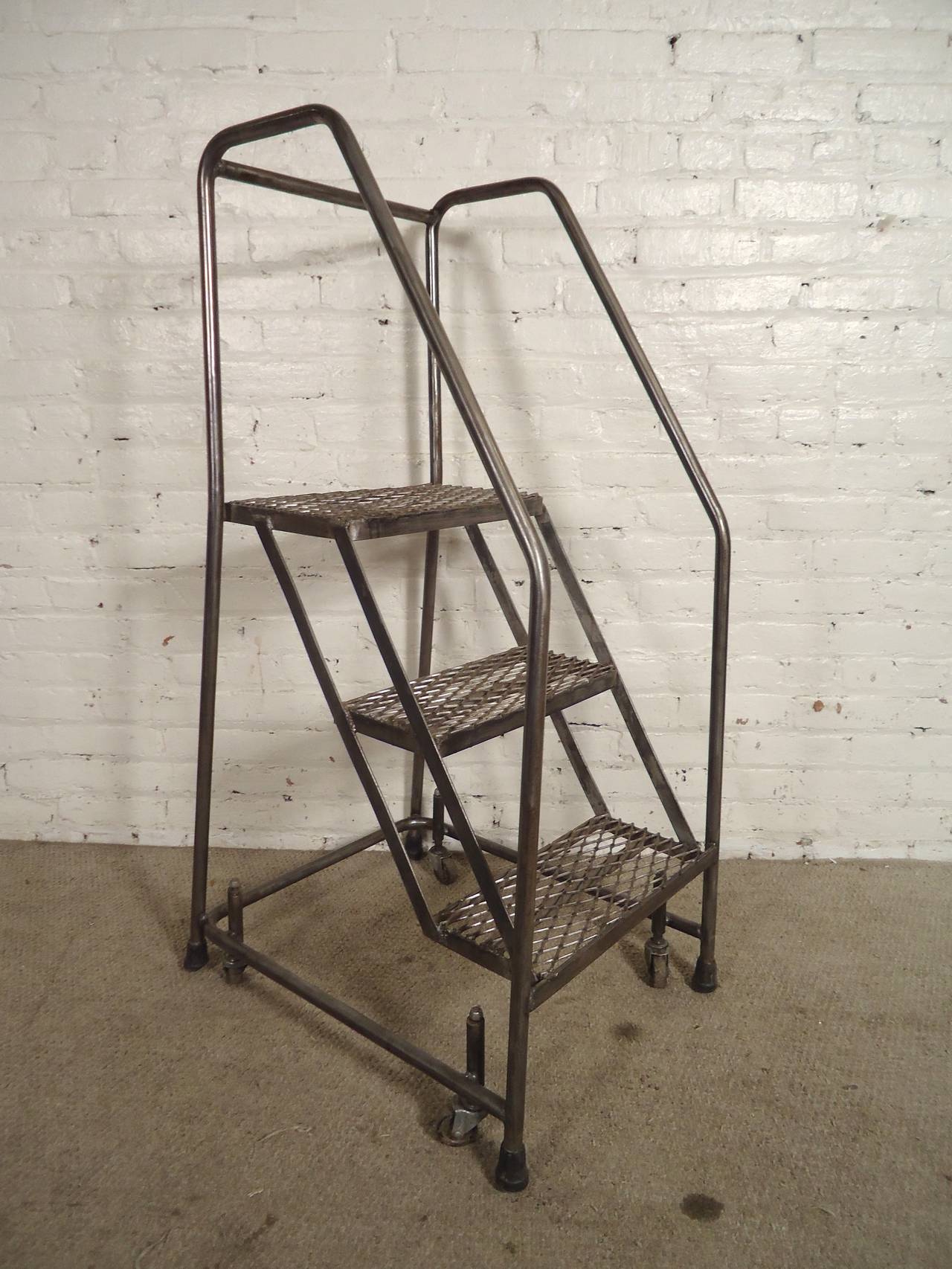 Refinished factory ladder, restored in a bare metal style. Great for high lofts and libraries. Mesh metal steps, 360 degree casters, strong handrails and locking mechanism.

(Please confirm item location - NY or NJ - with dealer)