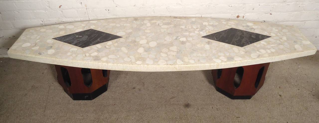 Iconic sculptural coffee table by American design master Harvey Probber. A substantial terrazzo stone top resists even the toughest coffee stains while Persian inspired cutouts help diffuse light throughout your space. Vintage construction has stood