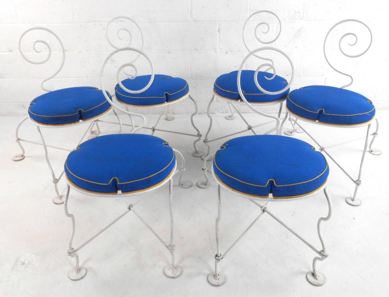 This unique set of chairs features wonderful bent rebar frames with upholstered cushions and one of a kind style. Seat dimensions measure 16
