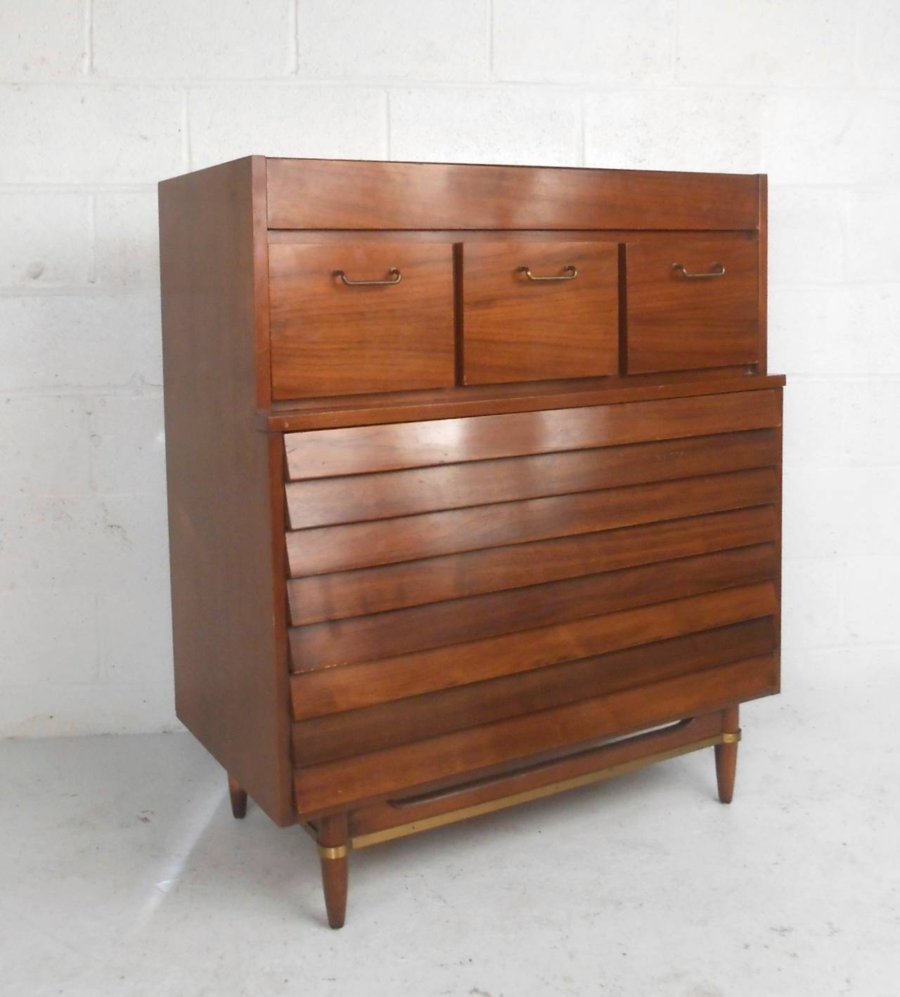 This beautiful louvered front dresser was designed by Merton Gershun for American of Martinsville and features the mid-century style and construction quality that keep these pieces in such high demand today. Unique brass trim on stretcher, as well