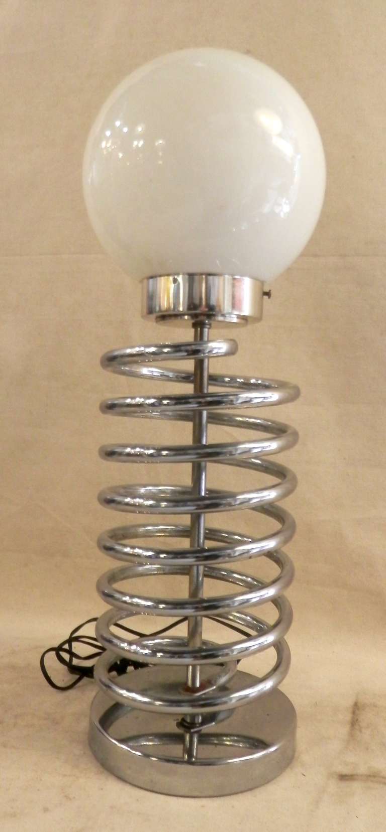 Mid-century Modern lamp in the form of chrome spring pillar with glass globe.

(Please confirm item location - NY or NJ - with dealer)