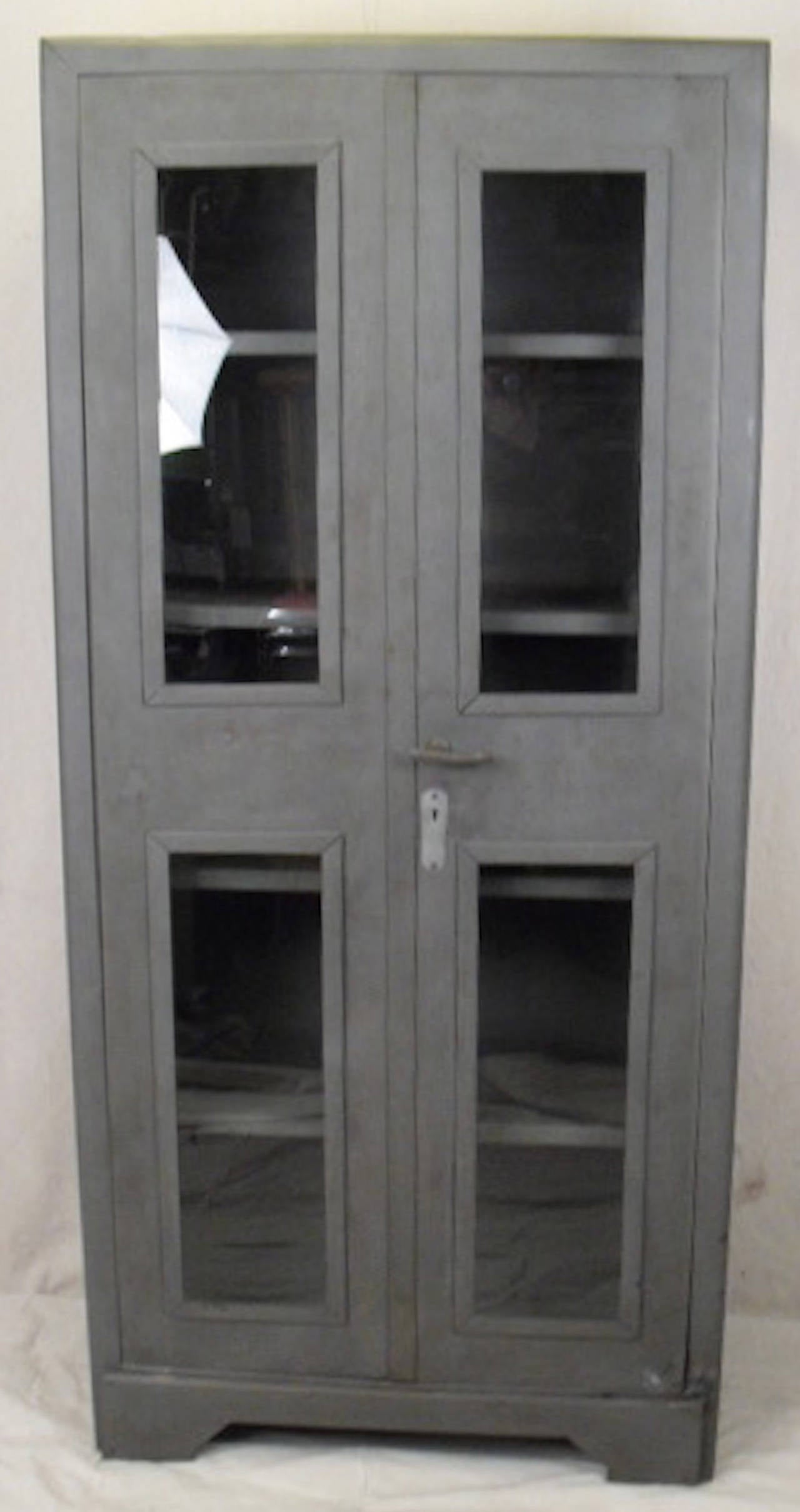 Industrial metal cabinet featuring two large doors with glass windows and four metal shelves. Perfect for use in bathroom or kitchen.

(Please confirm item location - NY or NJ - with dealer)