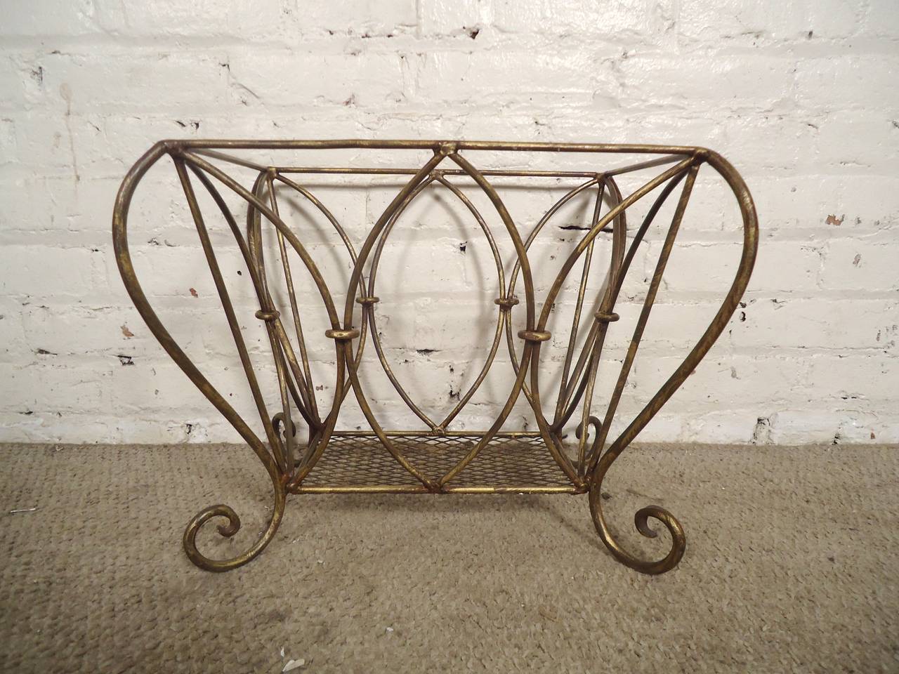 Vintage waste basket with a gold painted finish. Mesh bottom with lovely scrolling detail. Makes a great magazine rack.

(Please confirm item location - NY or NJ - with dealer)