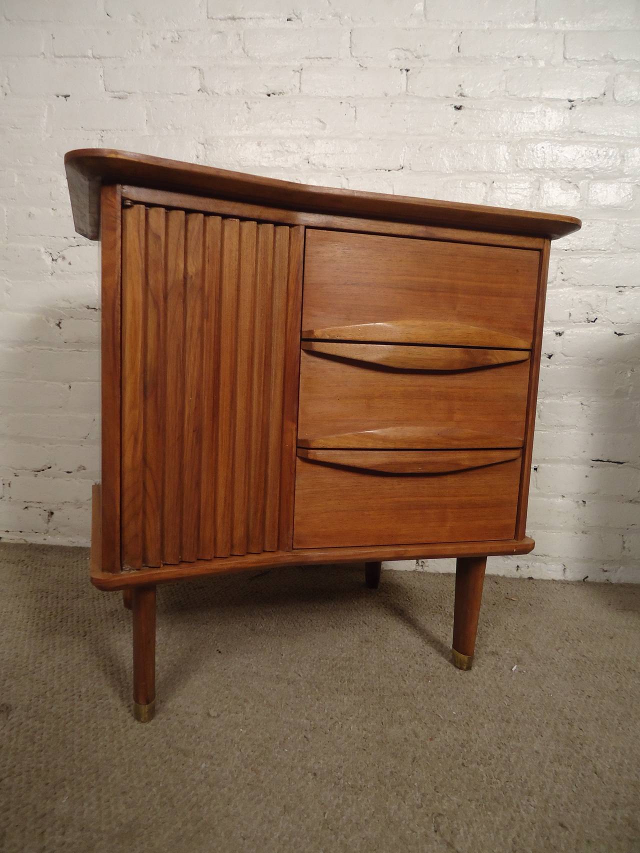 Vintage modern end tables with unusual angled tops, featuring sculpted side cabinets and three drawers. Warm walnut grain, molded wood handles, tapered legs.

(Please confirm item location - NY or NJ - with dealer)