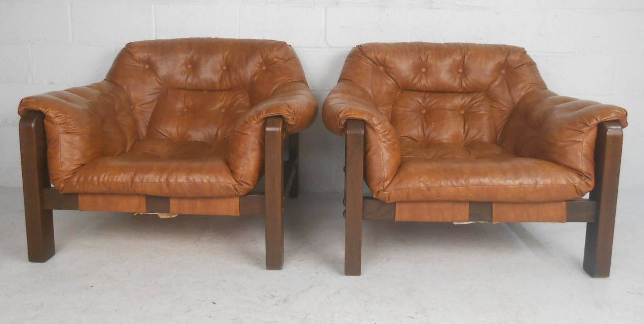 Matching pair of overstuffed leather lounge chairs with large ottoman. Very comfortable. Please confirm item location (NY or NJ) with dealer.