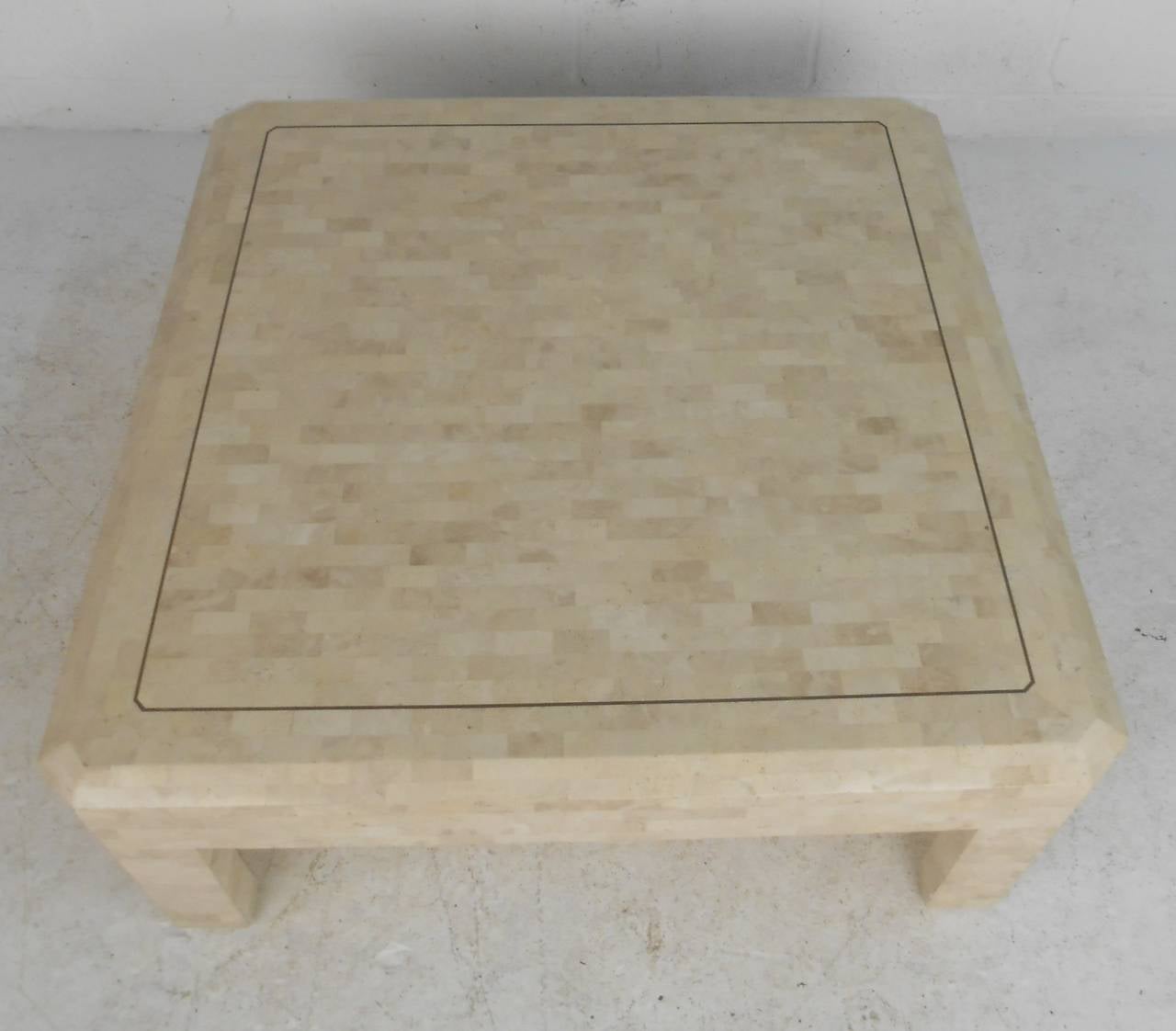 Vintage Maitland-Smith style coffee table features tessellated coral stone over wood core with brass inlay. Stylish square coffee table adds elegant mid-century modern vibe to any interior. Please confirm item location (NY or NJ) with dealer.