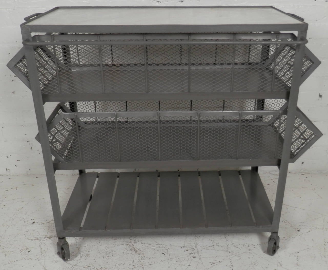Metal trolly on wheels featuring two large mesh sided drawers, lower storage platform and a marble insert on top. Heavy iron, solid construction. Makes a great kitchen island.

(Please confirm item location - NY or NJ - with dealer)