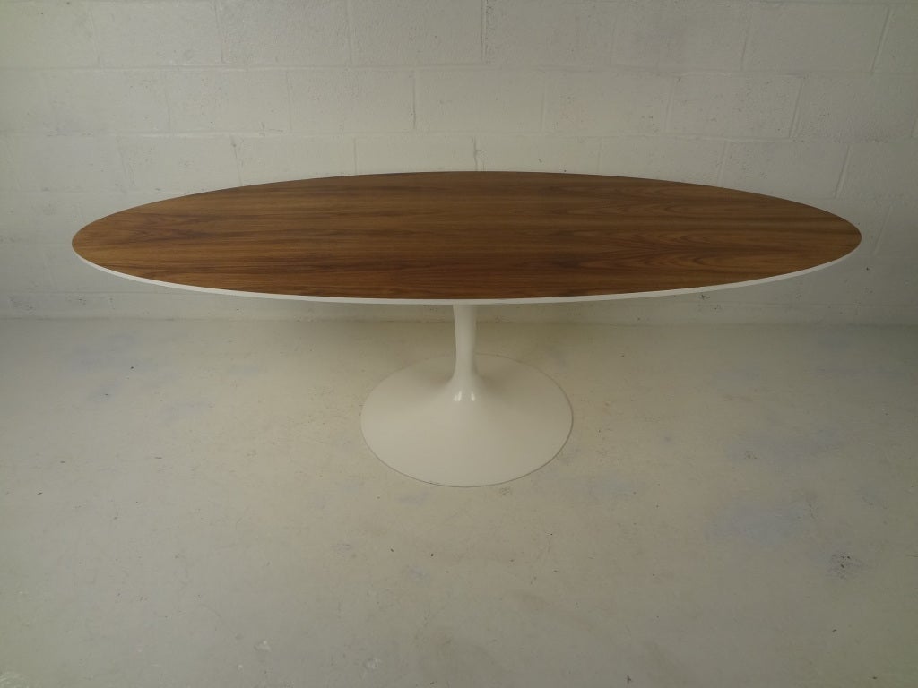 A custom fabricated table with a walnut veneer top supported by a heavy enameled aluminum base. Please confirm item location (NY or NJ) with dealer.