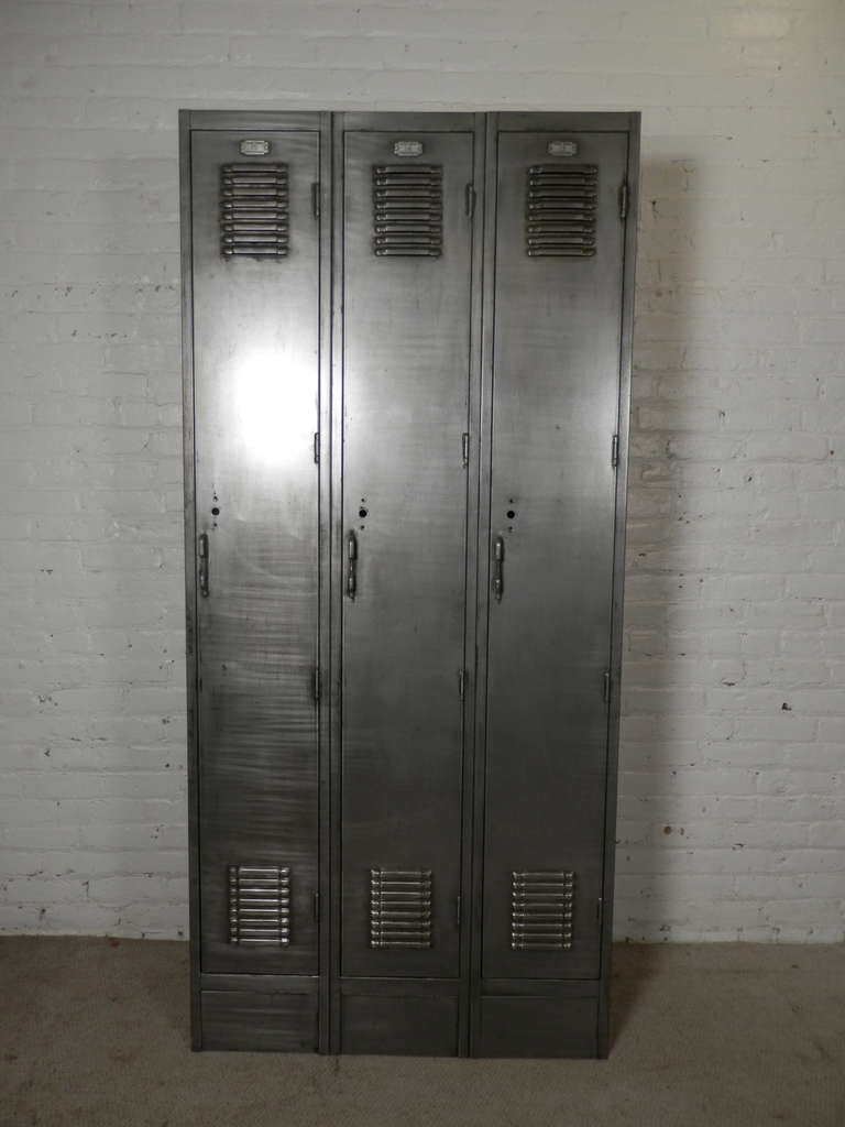 Large unit of old factory lockers refinished in a bare metal industrial style. Three door unit with top shelves, original number tags and working lift handles.
Great for storage in the home or office.

(Please confirm item location - NY or NJ -