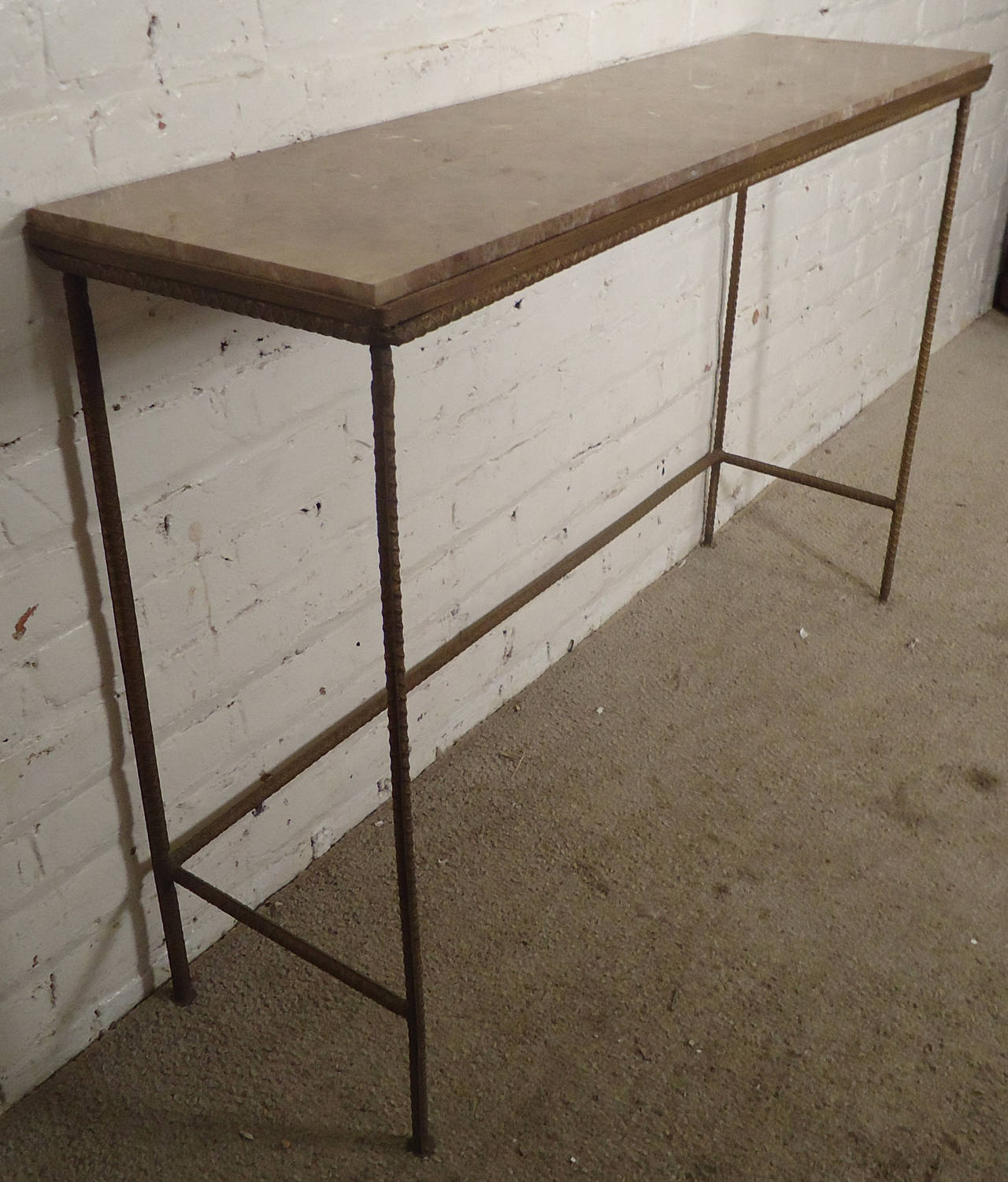 Great modern designed console table featuring a solid rebar base and a beautiful marble top. Attractive mix of clean modern lines with handsome industrial design.

(Please confirm item location - NY or NJ - with dealer)