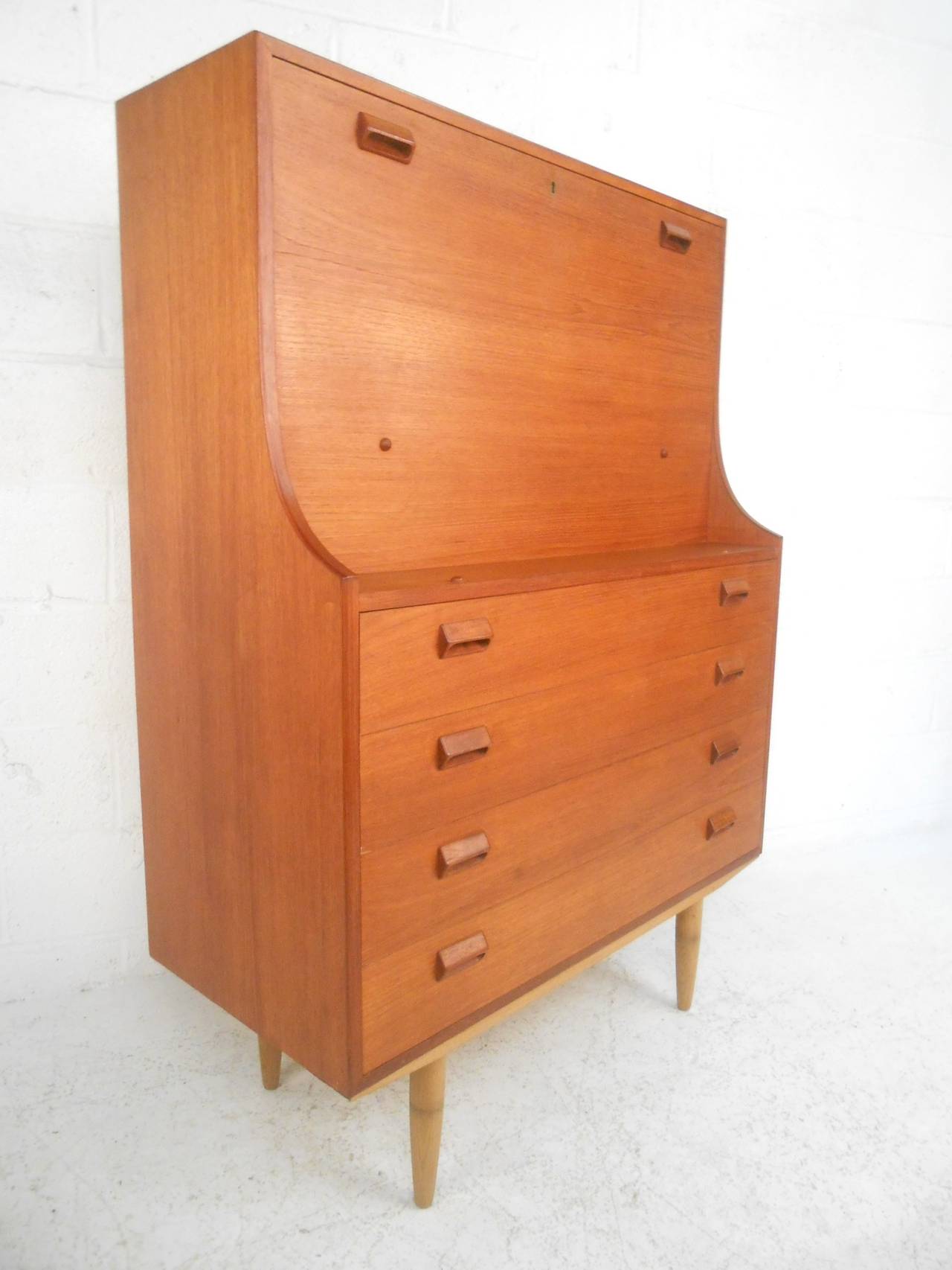 This beautiful teak secretary still has it's original Soborg Mobler manufacturer label. Combining spacious drop-front workspace with plenty of room for organization and storage this piece is the perfect mid-century solution to any interior. Please