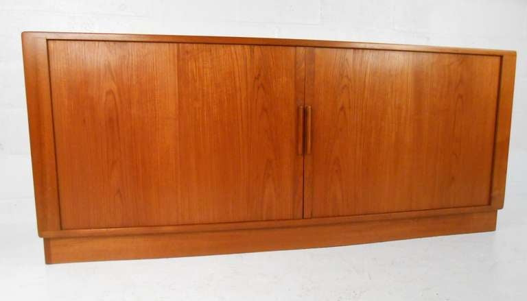 Mid-Century Modern teak tambour door cabinet by H.P. Hansen, Denmark. High quality cabinet with subtle bowed-front, containing four central trays flanked by four adjustable shelves. Please confirm item location (NY or NJ).