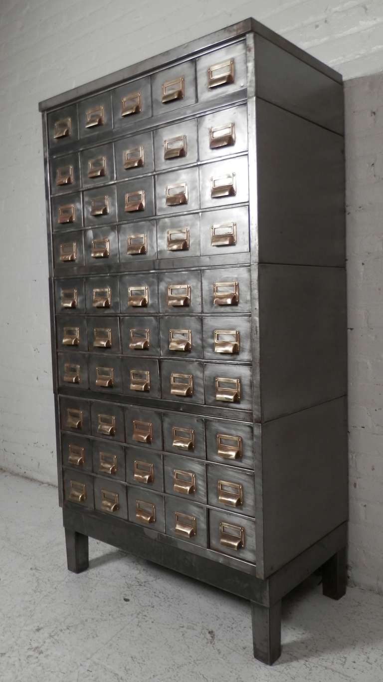 Heavy duty metal file cabinet, striped to bare metal and lacquered for a handsome industrial chic look. All original brass finger-pulls and card knobs. 50 drawers total.

(Please confirm item location - NY or NJ - with dealer)