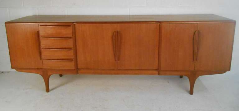 Large, exquisite blond teak sideboard, with beautiful woodwork detailing, sculptural handles and soft curves. French design, ca.1960.  Please confirm item location (NY or NJ) with dealer.