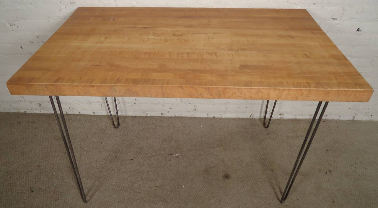 Industrial style table solidly built and beautifully restored with butcher block top set on elegant bent iron hair pin legs. Combining modern lines with factory style top.

(Please confirm item location - NY or NJ - with dealer).