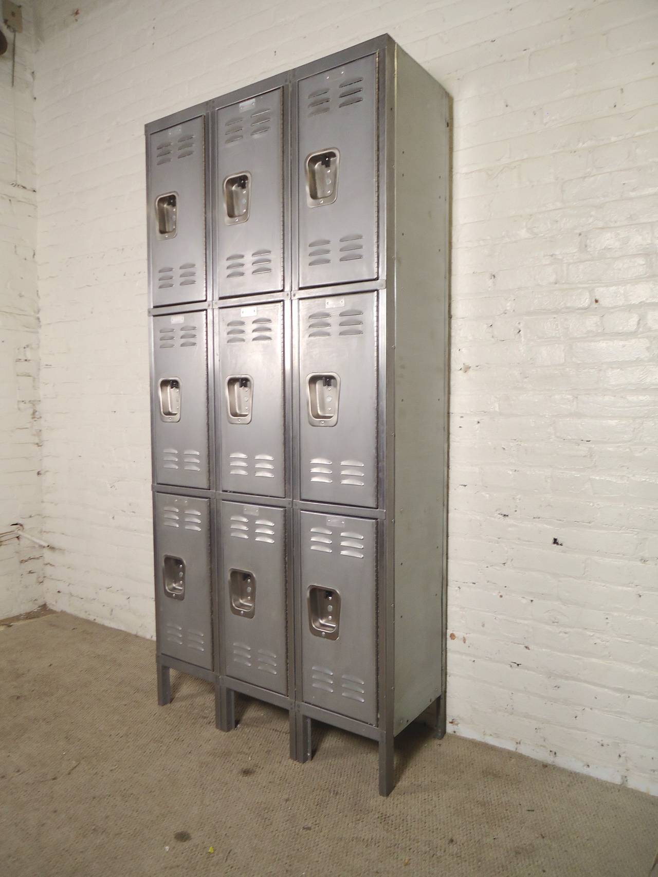 Industrial style metal locker unit with nine compartments. Each locker has vents and coat hangers. Great storage for kitchen or entry way in your modern home.
Inside: 12