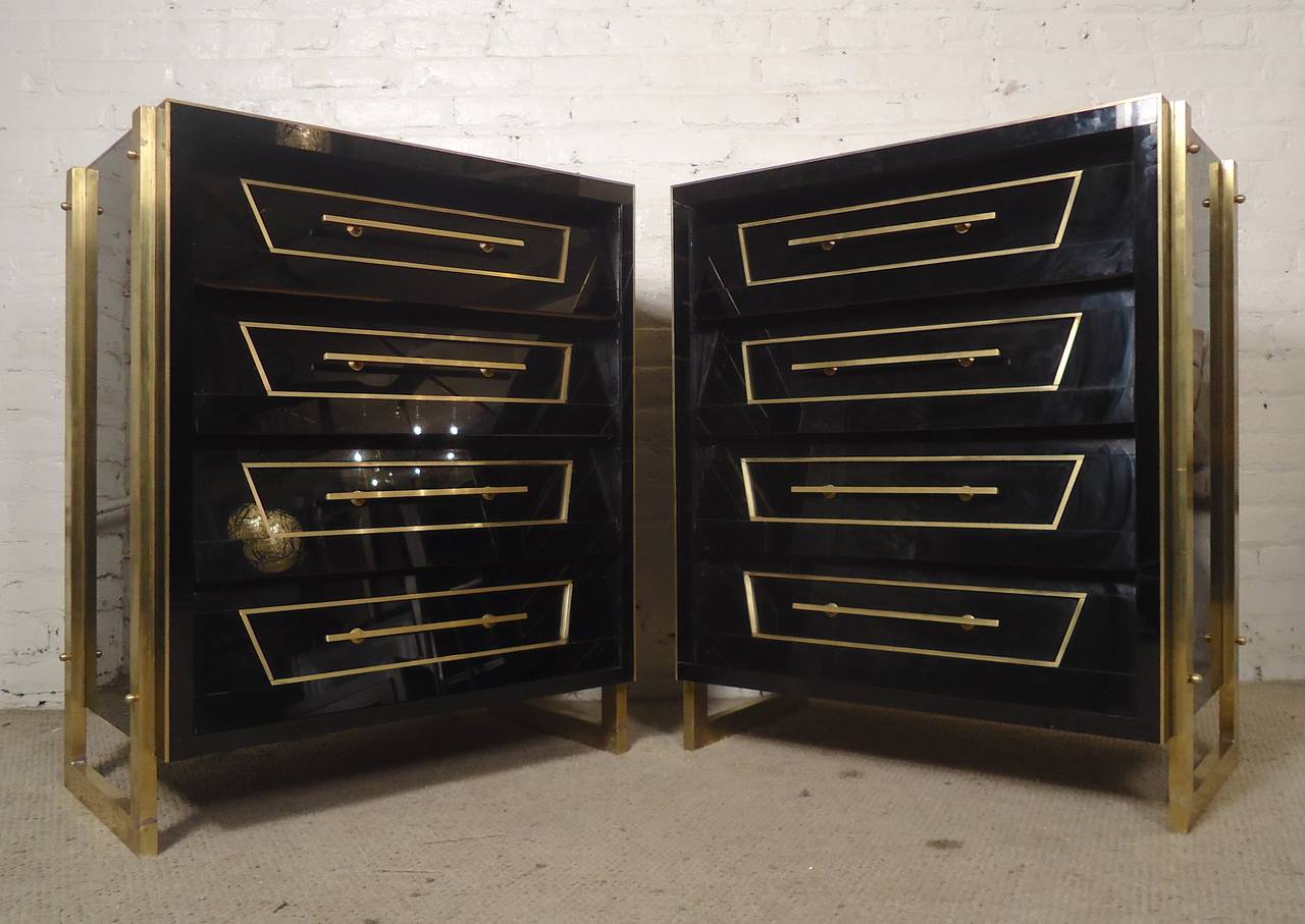 Vintage pair of black lacquer dressers with louvered drawers, striking brass trimming and hardware. Superb piano-like black finish, felt bottom drawers, strong and well built. Handsome and unique bedroom dressers or nightstands.

(Please confirm