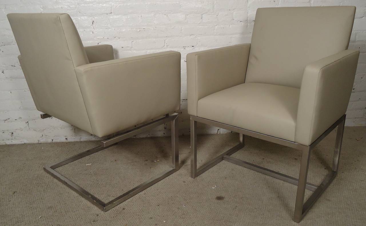Vintage modern arm chairs set on chrome bases. Modern 