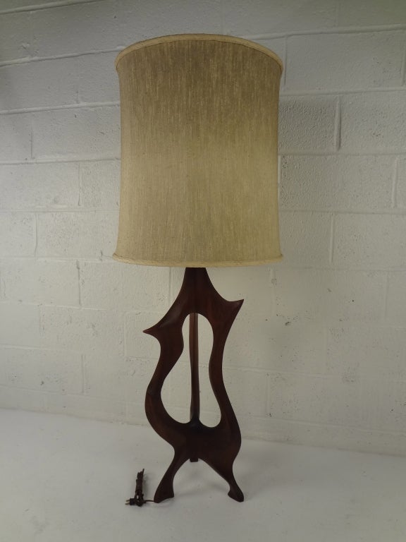 Fabulous hand-carved teak table lamp makes an impressive addition to any interior setting. Flowing sculptural details and vintage mid-century design add to the appeal.

Please confirm item location (NY or NJ) with dealer.