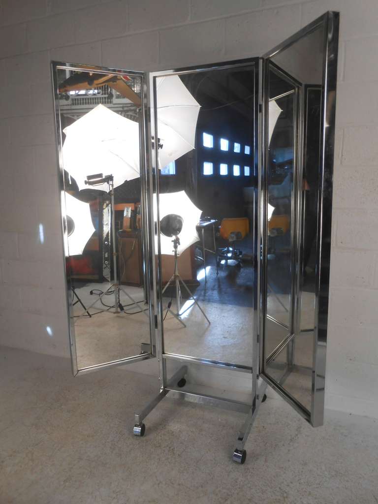 Double sided, freestanding three panel dressing mirror with heavy gauge metal construction. Well balanced unit moves effortlessly on casters and side panels are fully adjustable. Please confirm item location (NY or NJ) with dealer.