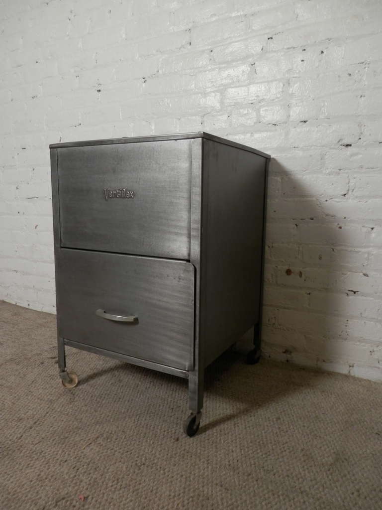 Vintage rolling file by Vertiflex featuring two cabinets designed to hold and keep hanging files neatly in an upright position. Sliding cover allows quick access to files as well as extra surface space. Newly restored in a handsome bare metal