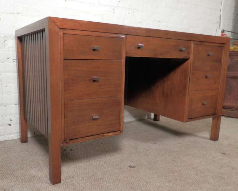 Large desk with five drawers, including two file size. Chrome pulls, rich walnut grain and slatted rosewood trim on the sides. Back is also finished.

(Please confirm item location - NY or NJ - with dealer).