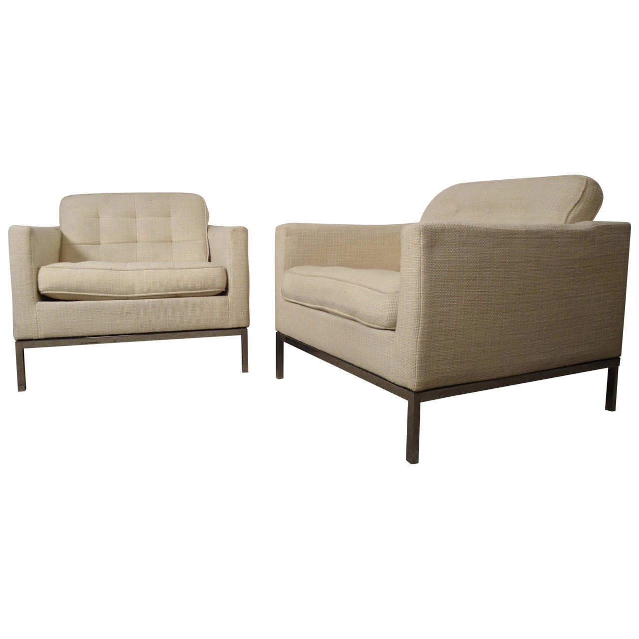 Vintage pair of comfortable armchairs designed by Knoll Associates.
Chairs feature off-white tufted upholstery and sleek polished chrome legs.
Both chairs come with optional arm protecting covers. 

(Please confirm item location - NY or NJ -