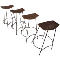 Four Mid-Century Iron and Wicker Stools in the Style of Arthur Umanoff