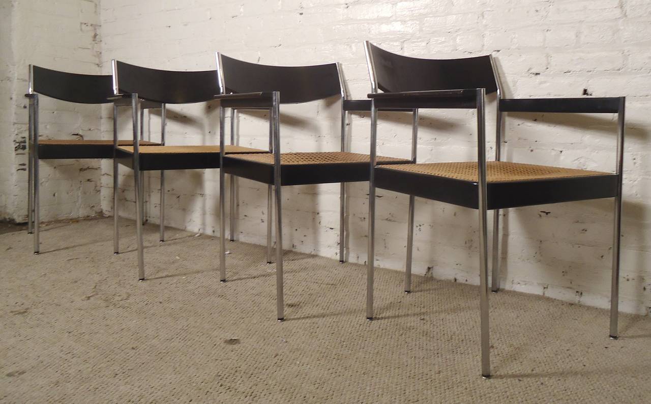 Set of Milo Baughman inspired polished chrome chairs with black wood frames and woven cane seats. Comfortable, sturdy with curved back.

(Please confirm item location - NY or NJ - with dealer)