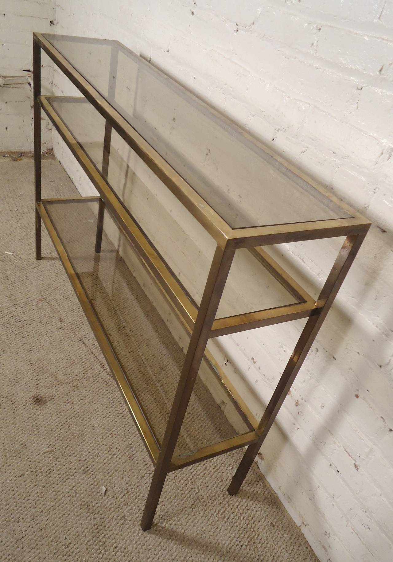 Mid-century long table with three levels of smoked glass. Handsome Mastercraft style, makes a great sofa or entry way table.

(Please confirm item location - NY or NJ - with dealer)