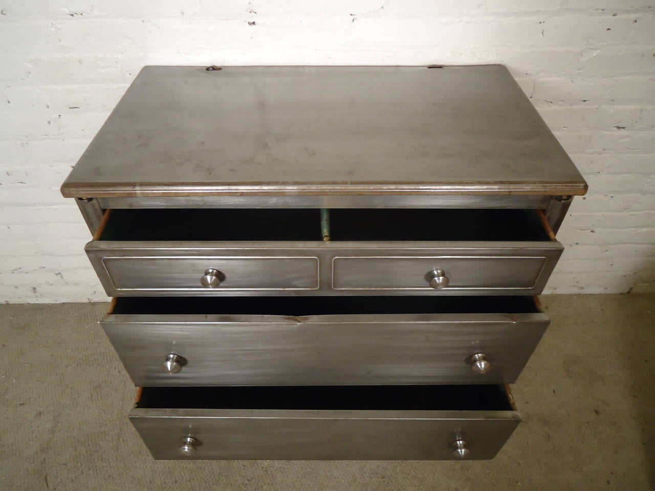 Industrial style finish, newly restored metal dresser on casters. Vintage chest of drawers given new life with a bare metal style finish. Now ready for your modern bedroom. 
Four drawer matching highboy available.

(Please confirm item location -