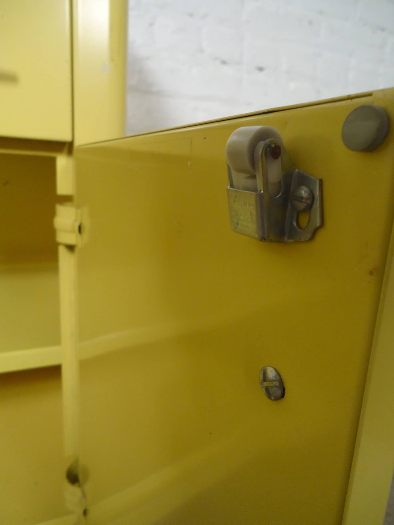 Bright yellow medical cabinet with thick plastic black top. Original chrome hardware and legs, nice drawer and cabinet storage.

(Please confirm item location - NY or NJ - with dealer)