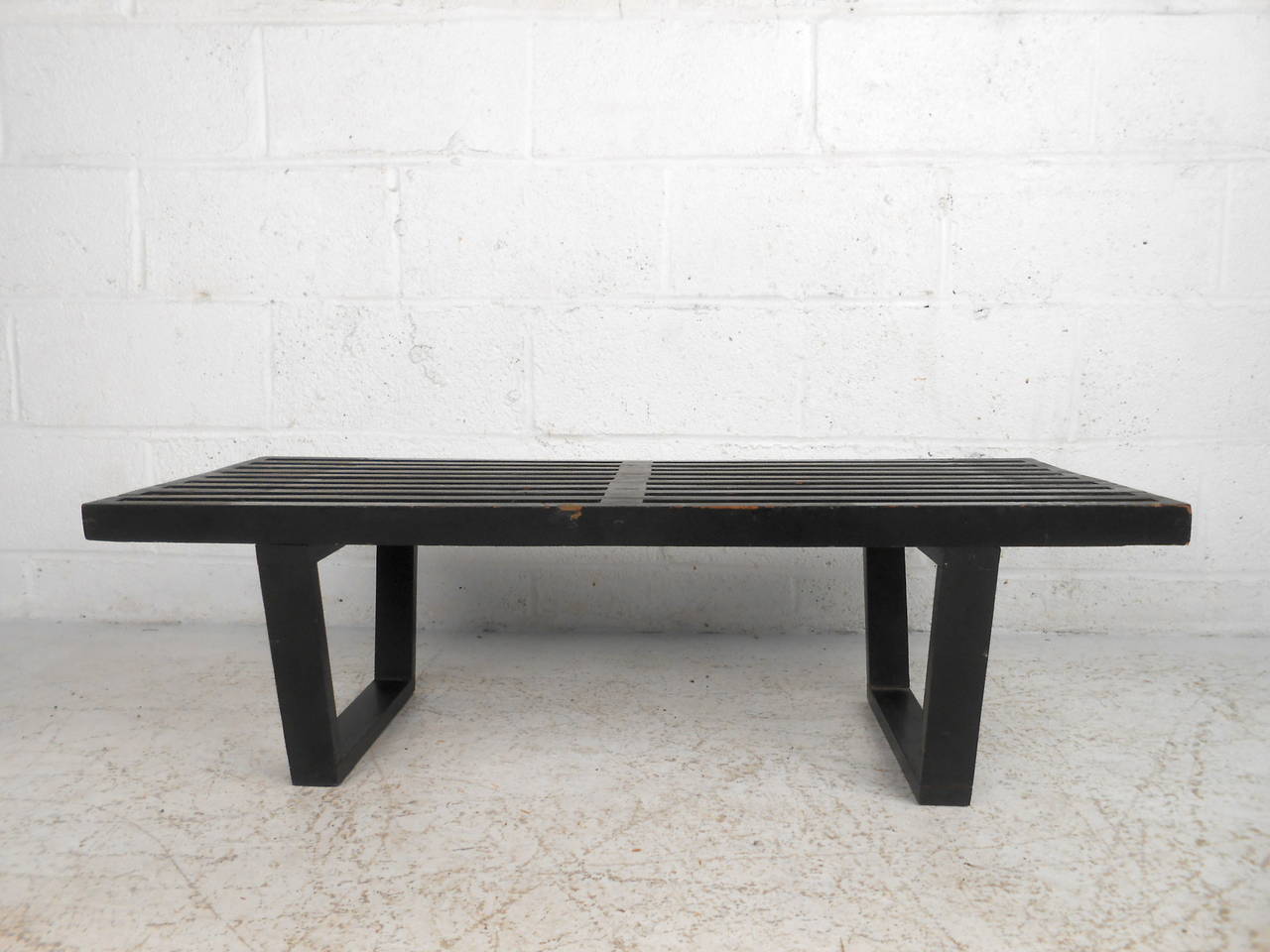 This midcentury slat bench by George Nelson features a compact size and ebonized finish which offer a bold modern accent to any home or office space. 

Please confirm item location (NY or NJ) with dealer.