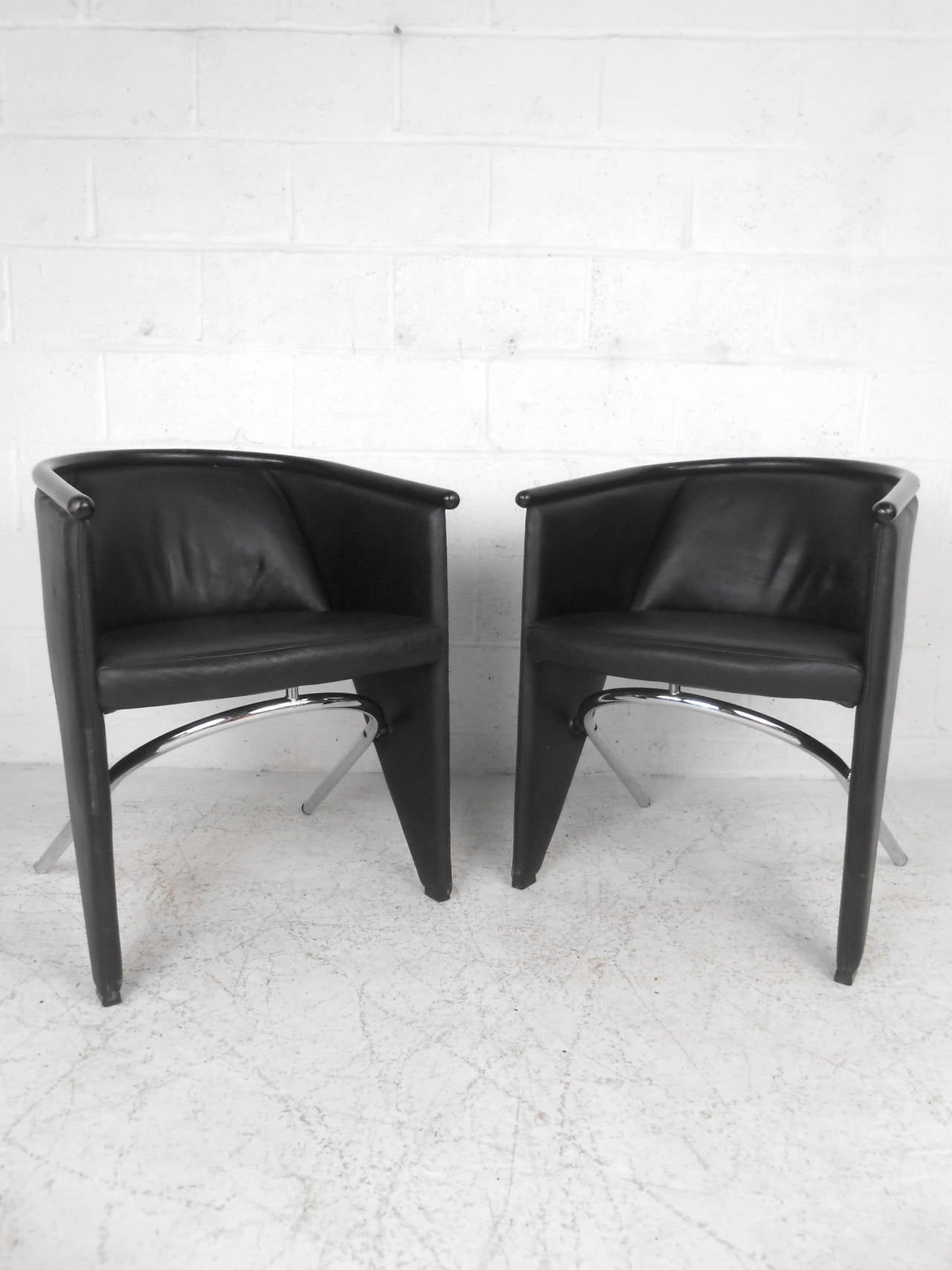 This pair of club chairs feature a unique construction combining beautiful black leather upholstery and polished chrome legs which offer a modern accent to any home or office space.  

Please confirm item location (NY or NJ) with dealer.